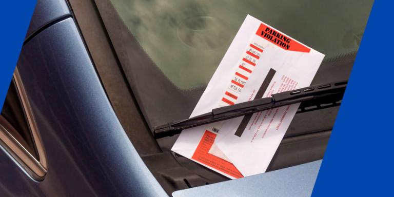 Parking ticket on windshield of a car.