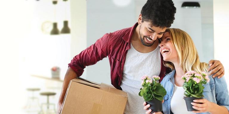 A couple enjoying a moment as they move in to a new house