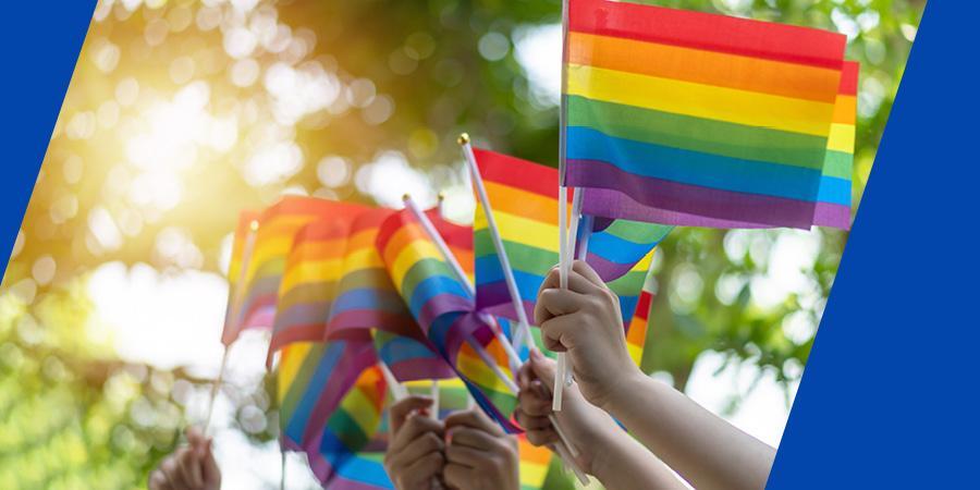 Hands holding pride flags