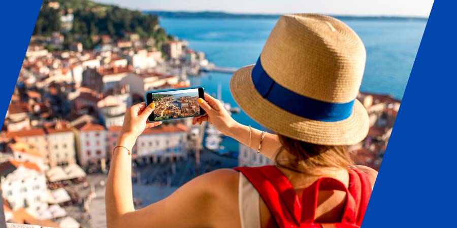 A traveler taking a picture of a city below