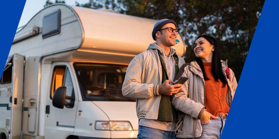 A couple standing in front of a rv