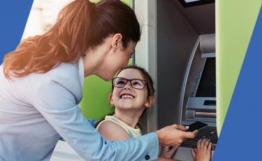 Woman and daughter at an ATM