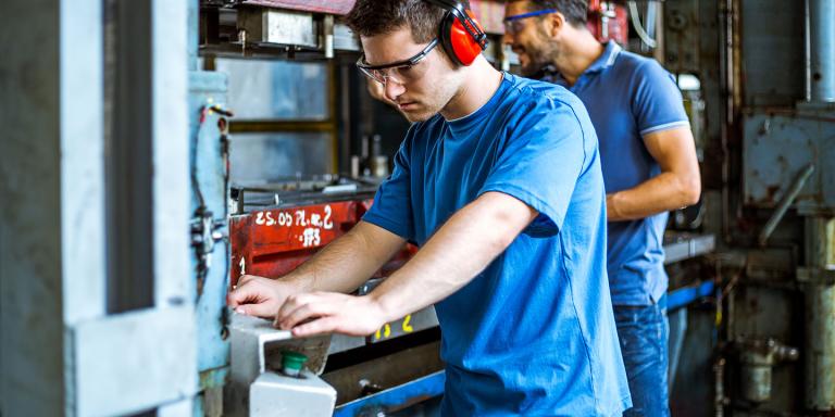 Man operating some manufacturing equipment 