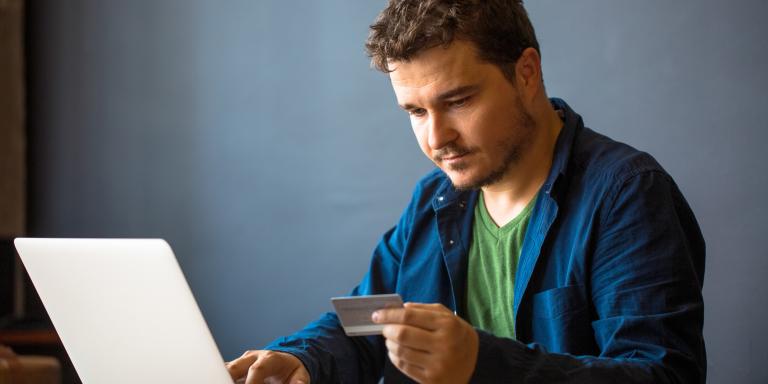 Pensive man checking his online bank account