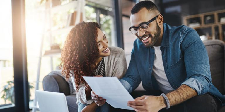 Couple looking at paperwork for mortgage refinancing