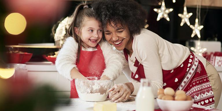 mother and daughter having fun making holiday cookies