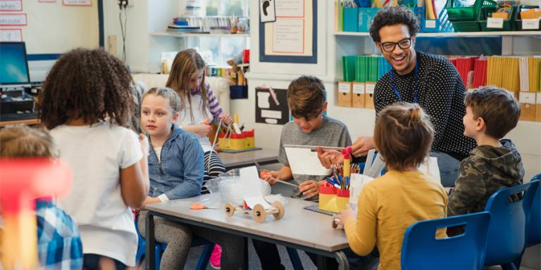 Teacher with students in classroom.