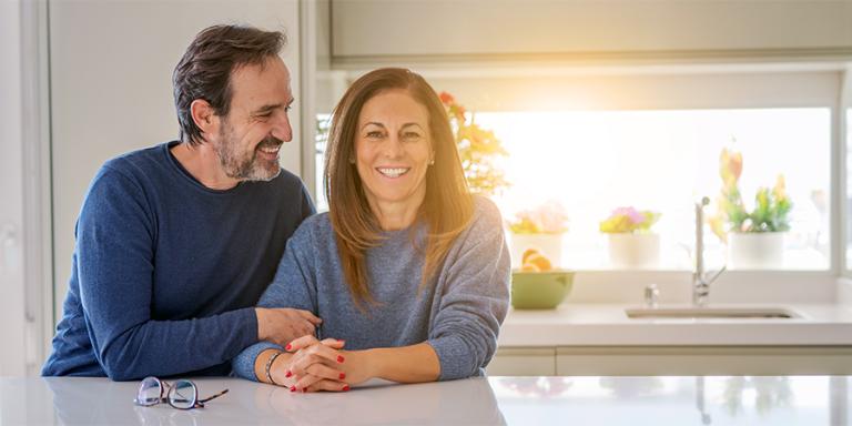 Man and a woman sitting in a sunny kitchen 