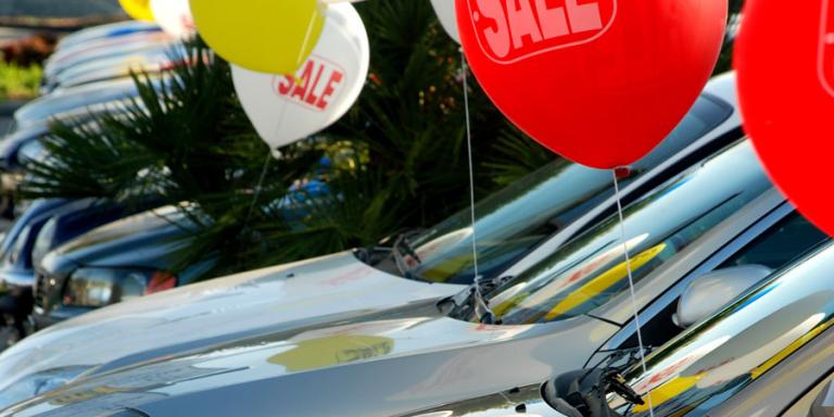 Car lot with balloons.