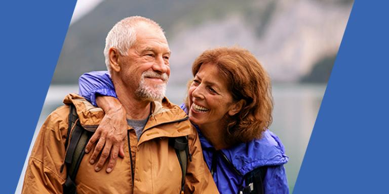 Man and woman at a lake with a mountain in the background