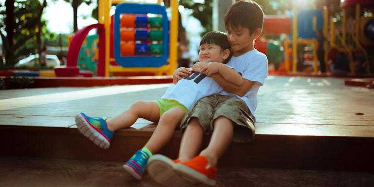 Children of Asian and Pacific Islander heritage playing on the playground.