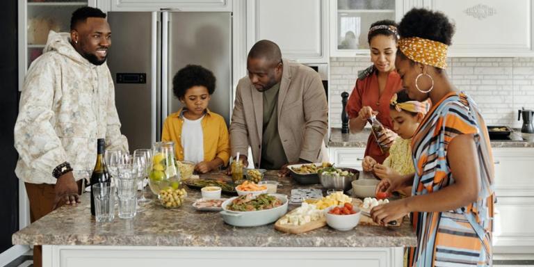Black family in a kitchen preparing food and celebrating Juneteenth.