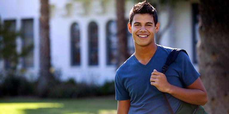 College student in front of building with backpack