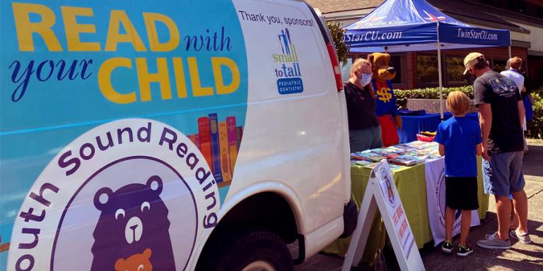 South Sound Reading Foundation van and tent set up in front of a school.