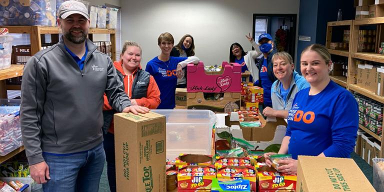 Team TwinStar packing backpacks for All Kids Win.