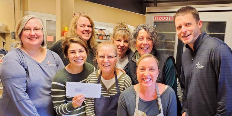 Check to pay off school lunch debt presented to North Thurston County school district.