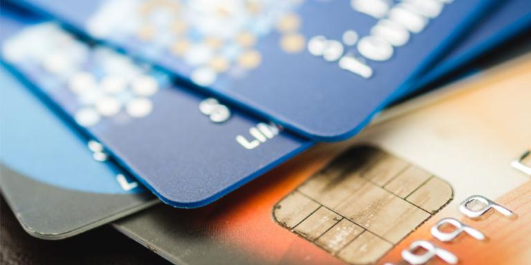 Stack of credit cards on a table.