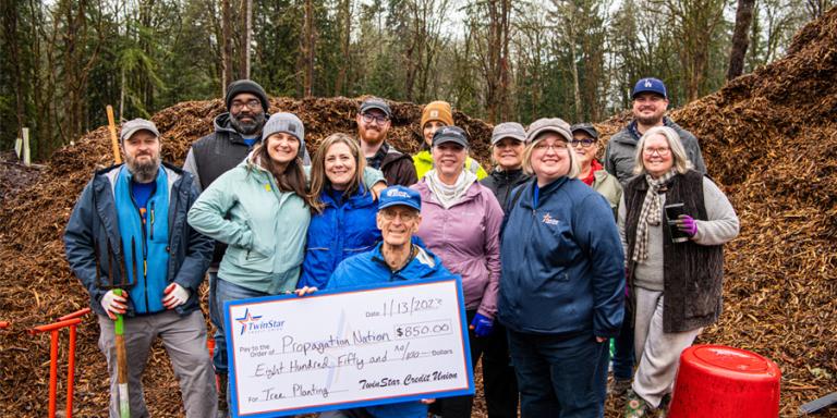 TwinStar employees present check for $850 to PropagationNation