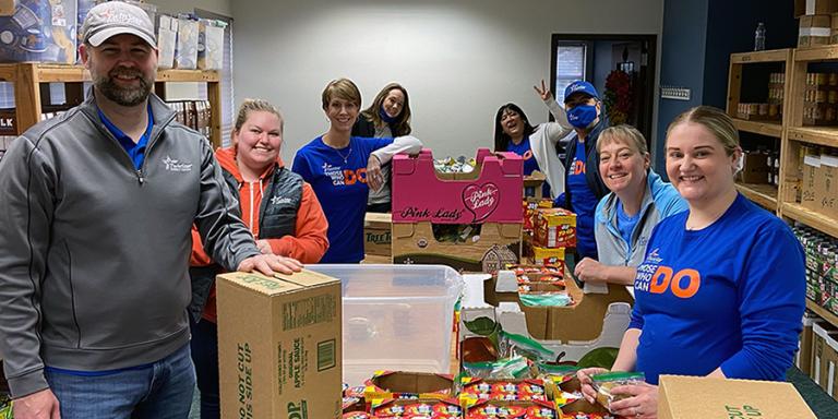 TwinStar Team Member volunteering packing food