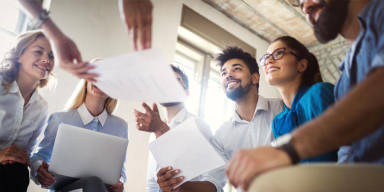 Smiling group of diverse businesspeople working in an office.