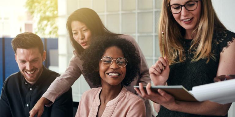Smiling group of diverse businesspeople working in an office.