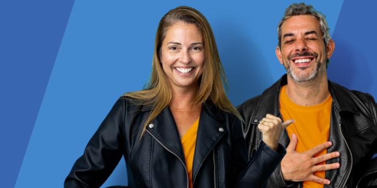 Woman and man holding motorcycle helmets.