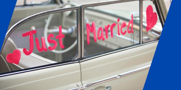 "Just Married" written on window of vintage car.