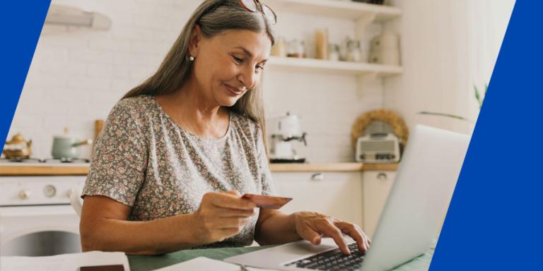 Smiling woman shopping online with a credit card.