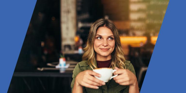 Smiling woman holding a cup of coffee