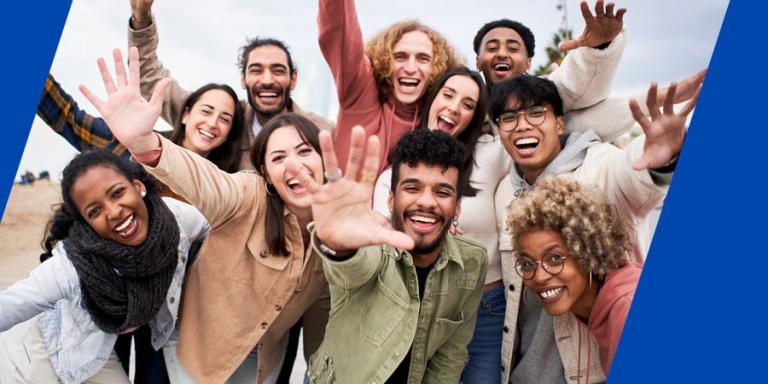 Diverse group of people smiling for the camera.