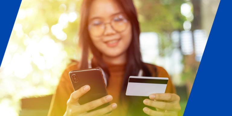 Asian woman shopping online with her phone.