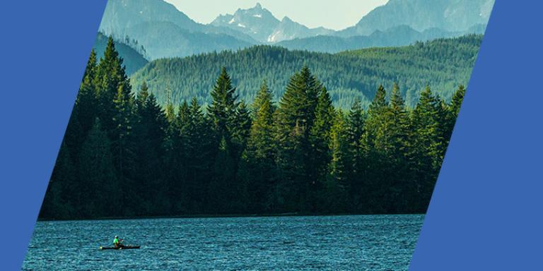Banner image of a kayaker on a Pacific Northwest lake with mountains in the background.