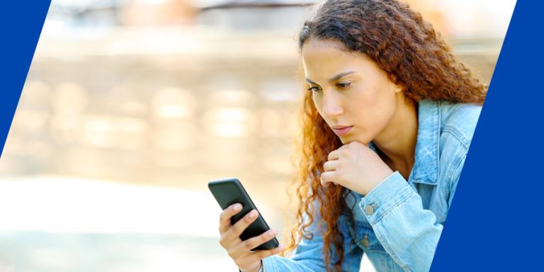 Concerned person looking at her emails on a phone.