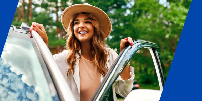 Happy woman with her new car.