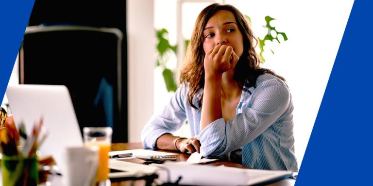 Pensive woman feeling worried while working on finances.