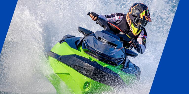 Jetski rider making a big splash on a sunny day.