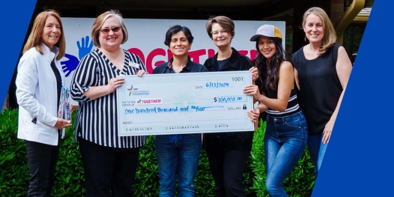 TwinStar team members presenting a check to TOGETHER!