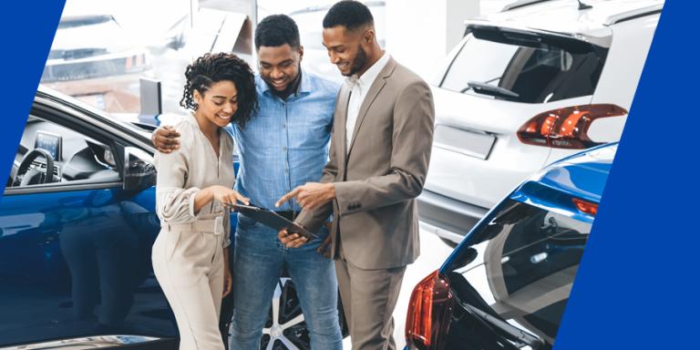 Black couple looking to buy a new car at a dealership.