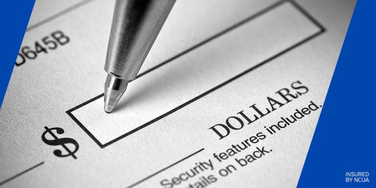 Close-up of a pen about to write on a check.