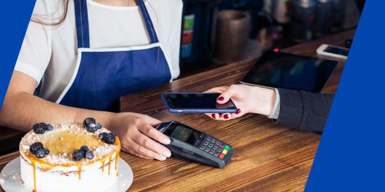 Customer paying a barista with her phone.
