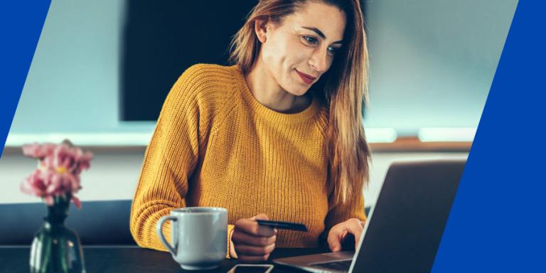 Woman looking at her laptop screen, shopping online.