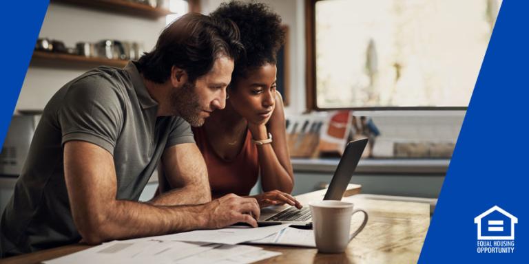 a couple looking at a laptop
