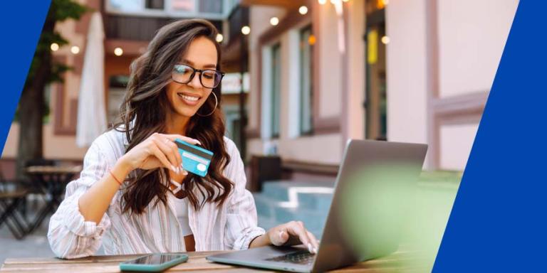 a women typing credit card information on a computer. 