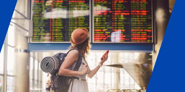 a traveling women looking at departure times. 