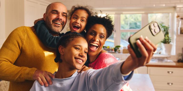 A family of four taking a selfie