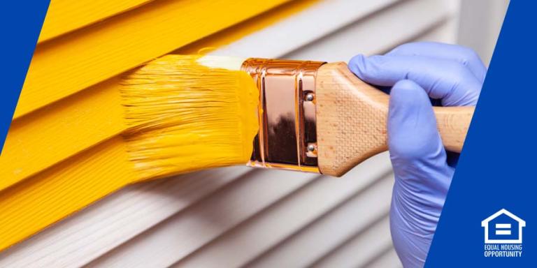 painting a house with yellow paint