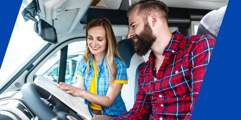 A couple navigating with a map in an RV