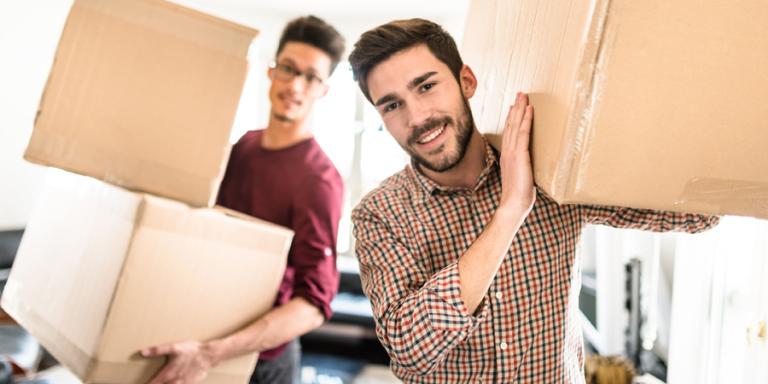 Men moving boxes into new home