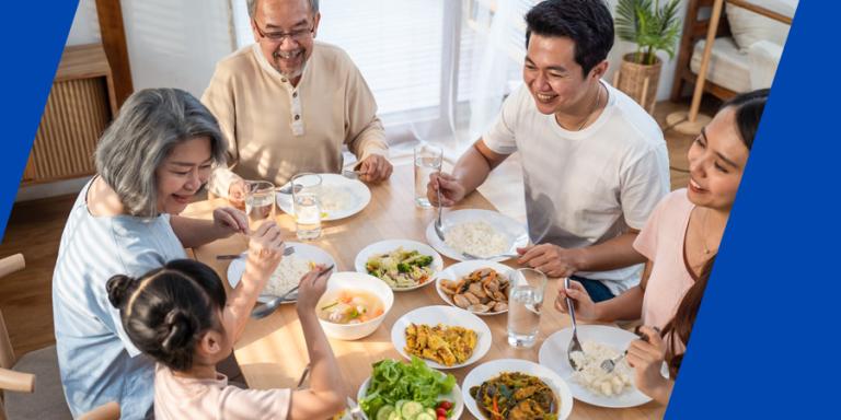 Multigenerational Asian family enjoying a big meal.